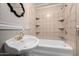 Cozy bathroom featuring a tub and shower combination with a decorative mirror and fixtures at 725 W Portland St, Phoenix, AZ 85007