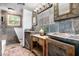 Unique bathroom with stone tile walls, dual sinks, and rustic wood cabinets at 725 W Portland St, Phoenix, AZ 85007
