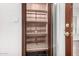 Unique entryway features a custom cabinet and glass door, seamlessly blending function and style at 725 W Portland St, Phoenix, AZ 85007