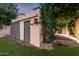 Exterior view of a storage building in a backyard setting with mature trees at 725 W Portland St, Phoenix, AZ 85007