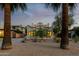 Charming home at dusk, highlighting the beautifully landscaped front yard and inviting windows at 725 W Portland St, Phoenix, AZ 85007