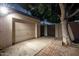 Exterior shot of the garage, featuring a side entry door and a paved parking area at 725 W Portland St, Phoenix, AZ 85007