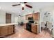Spacious kitchen featuring wood cabinets, granite countertops, an island, and stainless steel appliances at 725 W Portland St, Phoenix, AZ 85007