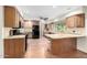 Spacious kitchen featuring wood cabinets, granite countertops, and black appliances at 725 W Portland St, Phoenix, AZ 85007
