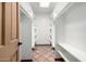 Bright, clean walk-in closet featuring white shelving, a tile floor, and a door leading outside at 725 W Portland St, Phoenix, AZ 85007