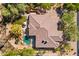 Overhead view of home highlighting roof, circular pool, desert landscaping, and covered patio area at 7335 E Quail Track Rd, Scottsdale, AZ 85266