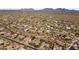 Sweeping aerial view of community showcasing sprawling desert landscape and mountainous horizon at 7335 E Quail Track Rd, Scottsdale, AZ 85266
