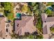 Overhead aerial view of home highlighting roof, circular pool, driveway, and desert landscaping at 7335 E Quail Track Rd, Scottsdale, AZ 85266