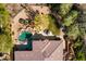 Stunning aerial view of the backyard, showcasing the pool, patio, landscaping and tile roof at 7335 E Quail Track Rd, Scottsdale, AZ 85266