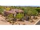 Beautiful home aerial view showcasing the tile roof, landscaping and long driveway at 7335 E Quail Track Rd, Scottsdale, AZ 85266