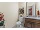 Powder room featuring a granite countertop vanity and decorative wall art at 7335 E Quail Track Rd, Scottsdale, AZ 85266