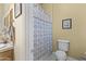 Cozy bathroom includes a vanity, toilet, and bathtub with decorative patterned shower curtain at 7335 E Quail Track Rd, Scottsdale, AZ 85266