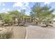 Charming desert home with mature trees and landscaping plus a private driveway creates great curb appeal at 7335 E Quail Track Rd, Scottsdale, AZ 85266