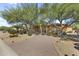 Beautiful home featuring desert landscaping, a private driveway and mature trees in a bright, sunny setting at 7335 E Quail Track Rd, Scottsdale, AZ 85266