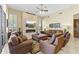 Inviting living room with stone fireplace, ceiling fan, and plush leather seating at 7335 E Quail Track Rd, Scottsdale, AZ 85266