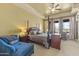 Cozy main bedroom features a four-poster bed, ceiling fan, and bright, natural light at 7335 E Quail Track Rd, Scottsdale, AZ 85266