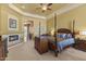 Main bedroom suite with a fireplace, sitting area, and comfortable furniture at 7335 E Quail Track Rd, Scottsdale, AZ 85266