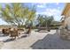 Enjoy outdoor living with a fire pit, kitchen, seating, and hot tub surrounded by lush landscaping at 7335 E Quail Track Rd, Scottsdale, AZ 85266