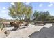 Relaxing patio with comfortable seating, a fire pit, and a hot tub with beautiful desert views at 7335 E Quail Track Rd, Scottsdale, AZ 85266