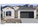 Charming single-story stucco home with a two-car garage and xeriscaped front yard against a mountain backdrop at 7370 W Buckhorn Trl, Peoria, AZ 85383