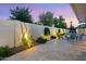 Charming backyard with a pool and comfortable seating, illuminated with warm lights, perfect for relaxing evenings at 7533 N 8Th St, Phoenix, AZ 85020