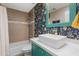Bathroom featuring a stylish vanity, colorful wallpaper, and a shower-tub combination at 7533 N 8Th St, Phoenix, AZ 85020