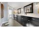 Bathroom with double sinks, stylish black cabinetry, quartz countertop, and modern fixtures at 7533 N 8Th St, Phoenix, AZ 85020