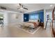 Bright main bedroom features a modern ceiling fan, herringbone accent wall, and access to the outdoors at 7533 N 8Th St, Phoenix, AZ 85020