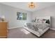 Comfortable bedroom with a patterned duvet cover, light fixture, and lots of natural light from the window at 7533 N 8Th St, Phoenix, AZ 85020