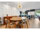 Dining area boasts modern light fixture, stylish wallpaper, and seamless flow to kitchen at 7533 N 8Th St, Phoenix, AZ 85020