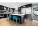Modern kitchen features dark cabinetry, a large island with seating, and stainless steel appliances at 7533 N 8Th St, Phoenix, AZ 85020