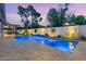 Beautifully lit backyard pool with a waterfall feature and a spacious deck, creating a tranquil ambiance at 7533 N 8Th St, Phoenix, AZ 85020