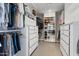 Spacious walk-in closet with custom shelves, drawers, and ample storage space for clothes and shoes at 7533 N 8Th St, Phoenix, AZ 85020