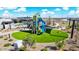 Aerial view of a community playground with a climbing structure, slide, and shade canopies surrounded by landscaping at 7836 E Quintana Ave, Mesa, AZ 85212