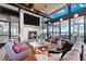 Inviting living room with a fireplace, plush seating, and large windows offering scenic community views at 7836 E Quintana Ave, Mesa, AZ 85212