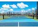 Outdoor pickleball court with blue and green playing surface, surrounded by fencing in a recreational area at 7836 E Quintana Ave, Mesa, AZ 85212