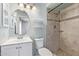 Updated bathroom with a modern vanity, decorative mirror, and tiled shower at 820 W Hononegh Dr, Phoenix, AZ 85027