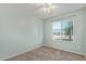 Minimalist bedroom with window bringing in natural light and neutral carpet at 820 W Hononegh Dr, Phoenix, AZ 85027