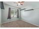 Bright bedroom featuring neutral paint, a window, ceiling fan and modern floating shelves at 820 W Hononegh Dr, Phoenix, AZ 85027