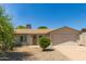 Charming single-story home featuring desert landscaping, a two-car garage, and a cozy front porch with security door at 820 W Hononegh Dr, Phoenix, AZ 85027