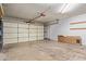 Spacious garage featuring a rolling door and abundant storage space at 820 W Hononegh Dr, Phoenix, AZ 85027