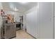 Functional laundry room with modern washer/dryer and ample storage shelving and cabinets at 820 W Hononegh Dr, Phoenix, AZ 85027