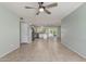 Open-concept living space with tile floors and views into the kitchen and backyard, enhanced by natural light at 820 W Hononegh Dr, Phoenix, AZ 85027