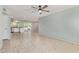 Bright living room with tile flooring, leading into a modern kitchen with sliding glass doors at 820 W Hononegh Dr, Phoenix, AZ 85027