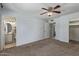 Large main bedroom with a ceiling fan, carpet, and an ensuite bathroom at 820 W Hononegh Dr, Phoenix, AZ 85027