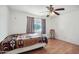 Cozy bedroom featuring wood floors, a ceiling fan, and a patterned blanket at 8343 W Calle Lejos --, Peoria, AZ 85383