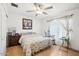 Cozy bedroom featuring wood floors, a ceiling fan, and a quaint rocking chair at 8343 W Calle Lejos --, Peoria, AZ 85383