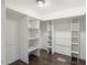 Walk-in closet featuring custom shelves and hanging rods and hardwood flooring at 8343 W Calle Lejos --, Peoria, AZ 85383