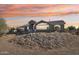 Charming single-story home featuring a desert landscape and a beautiful sunset backdrop at 8343 W Calle Lejos --, Peoria, AZ 85383