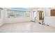 Bright living room features tile floors, large windows, and a wood-paneled front door at 8343 W Calle Lejos --, Peoria, AZ 85383